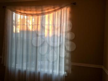 gold sunlight streams through curtains for golden design background on room wall