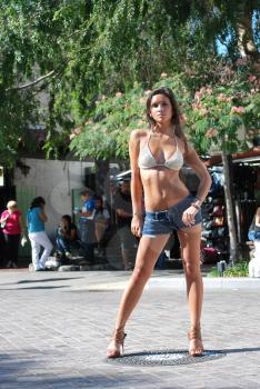 Sexy beautiful hot shorts bikini model brunette outdoors city nature background flat abdomen in shape