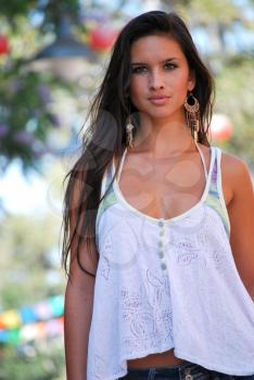 Young female model brunette pretty spring white top earrings outdoors