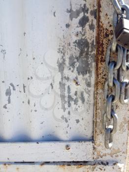 Padlock lock and chain old metal door locked closed