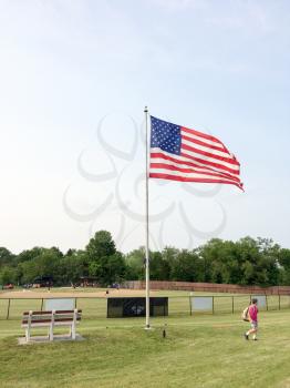 baseball field with american flag on a summer day