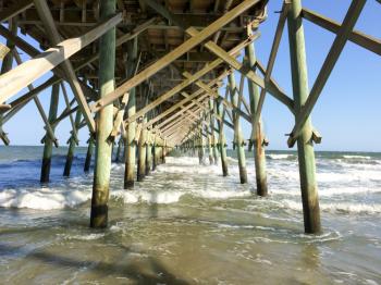 wood beach pier rescue lane underneath view with waves charleston south carolina