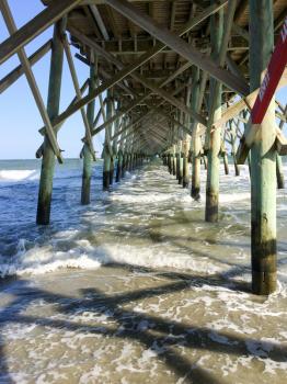 wood beach pier rescue lane underneath view with waves charleston south carolina