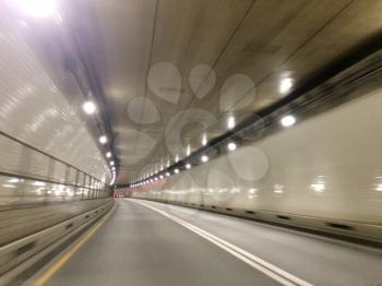 fast moving blurred car tunnel from driver view underground with light