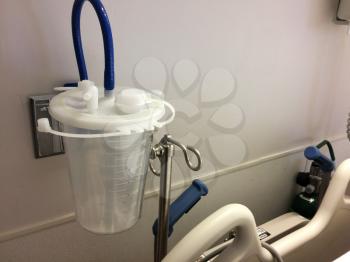 hospital room equipment connections suction clear container and hose