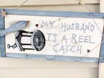husband is reel catch funny sign at country home as wooden sign