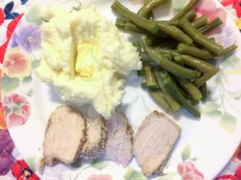 pork green beans mashed potatoes on plate for homestyle american country style dinner