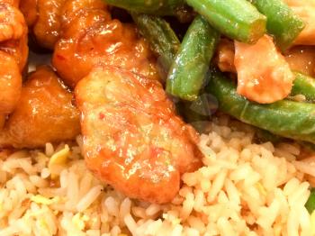 Chinese takeout food orange chicken green beans fried rice close up