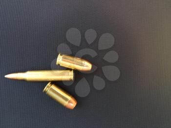 Bullets rifle handgun pistol firearm closeup on black backgound text space design element business card sign