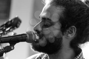 Portrait of a young guitarist during a musical performance. Black and white image.