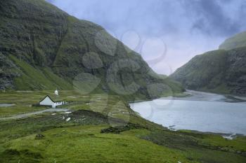 Valley and Saksun village landscape showing white church, Faroe Islands