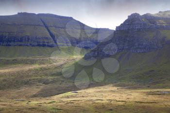 Dramatic landscape of Faroe islands showing pyramid mountains