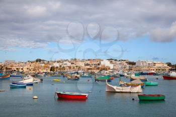 Marsaxlokk, Malta - 5 January 2020: colorful boats in the village port