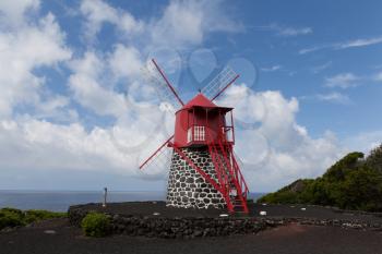 Typical mill made from black volcanic rock and red blades