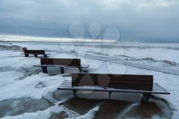 Benches on Parnu beach in winter, Estonia