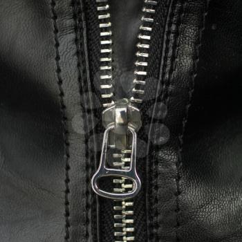 Close up on a silver metal zipper on a leather jacket