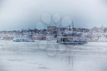 Ferry boat in ice on St-Lawrence river between Quebec and Levis in Canada during winter season.