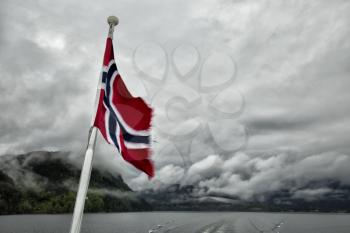 Norwegian flag with the fjord in background 