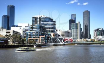 Touristic boat on Yarra river with downtown Melbourne in background in Australia