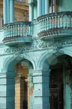 Detail of neoclassical balcony with column in mint green in Old Havana in Cuba