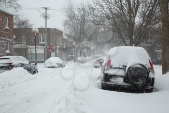 Car parked during in a street during a snowstorm in Montreal in  Canada