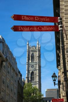 Old Montreal street sign with Notre Dame basilica in background