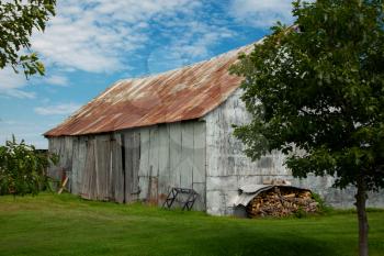 Side view of a little barn in a meadow during autumn season