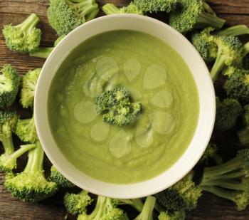 Top view of a broccoli soup in a white bowl 