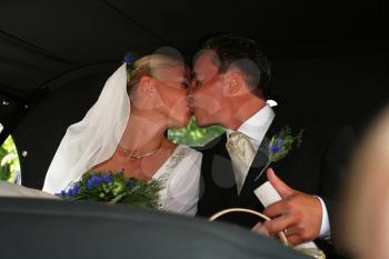 Royalty Free Photo of a Newlywed Couple Kissing