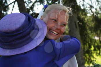Royalty Free Photo of a Woman Hugging a Bride