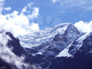 Royalty Free Photo of the Top of a Mountain Range and Clouds in the Sky