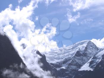 Royalty Free Photo of Snowcapped Mountains Under Clouds