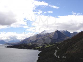 Royalty Free Photo of Clouds, Mountains and Water
