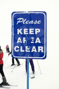 Royalty Free Photo of a Sign at a Ski Slope Requesting Area Be Kept Clear