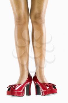 Royalty Free Photo of a Woman's Bare Legs and Red High Heel Shoes