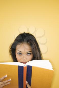 Royalty Free Photo of a Woman Looking Over a Book