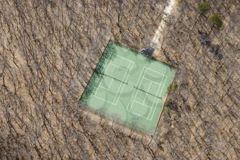 Royalty Free Photo of an Aerial of a Tennis Court in a Wooded Area