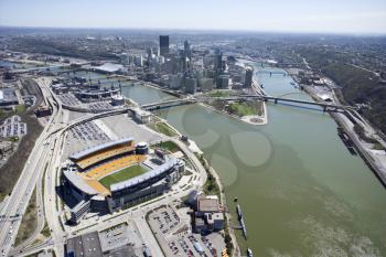 Aerial view of Pittsburgh, Pennsylvania with skyscrapers and stadium and rivers.