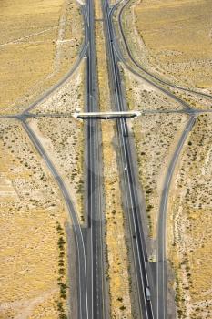 Aerial view of desert highway with overpass.