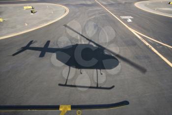 Royalty Free Photo of an Aerial of a Helicopter Shadow on an Airport Runway Pavement