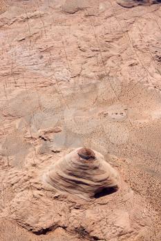 Aerial of extruding rock formation in desert landscape of Utah, USA.