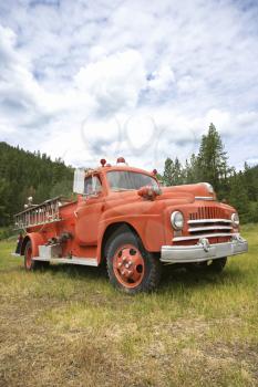 Royalty Free Photo of an Old Fire Truck in a Field