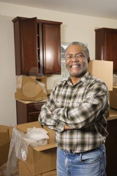 Royalty Free Photo of a Man in a Kitchen With Moving Boxes
