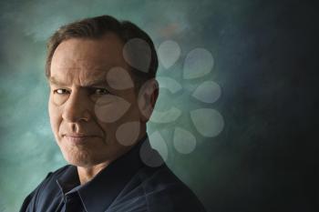 Royalty Free Photo of Serious Middle-Aged Man on a Studio Background