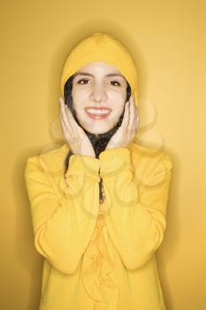 Royalty Free Photo of a Woman Wearing a Yellow Raincoat Smiling
