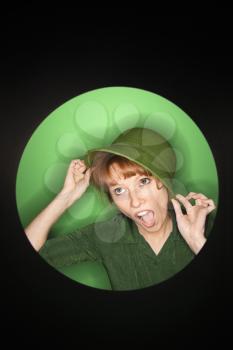 Royalty Free Photo of a Woman Tilting a Hat