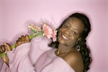 Royalty Free Photo of a Smiling Woman Holding Flowers