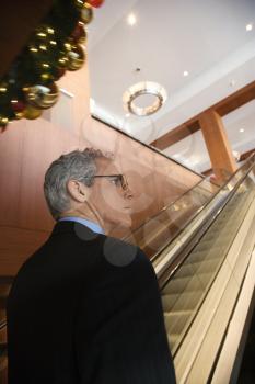 Royalty Free Photo of a Man in a Suit on an Escalator 