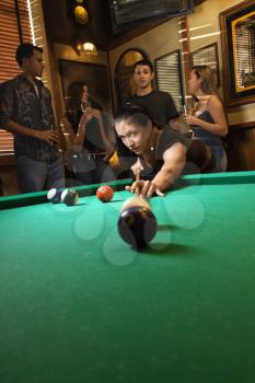 Royalty Free Photo of a Woman Preparing to Hit Pool Balls While Playing Billiards