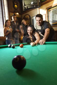 Royalty Free Photo of a Woman Preparing to Hit Pool Balls While Playing Billiards